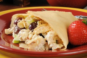 chicken salad with grapes and strawberries in a crepe