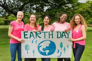 people wearing pink and holding a sign that says Earth Day
