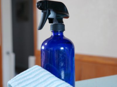 spray bottle and cleaning rag in kitchen