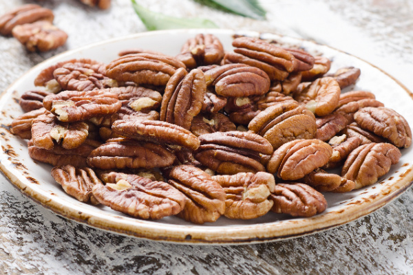 Pecan nuts on wooden table.