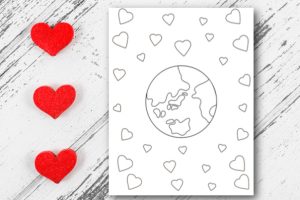 red hearts on white wooden table with earth coloring sheet