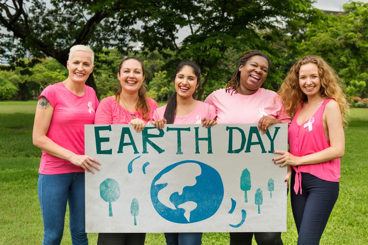 people holding a sign that says earth day