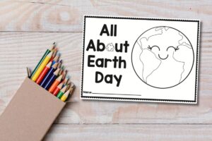 all about earth day drawing book on table with colored pencils