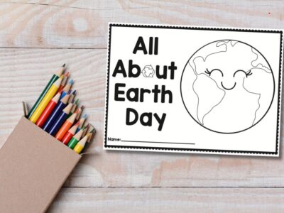 all about earth day drawing book on table with colored pencils