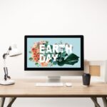earth day graphic on computer screen sitting on desk